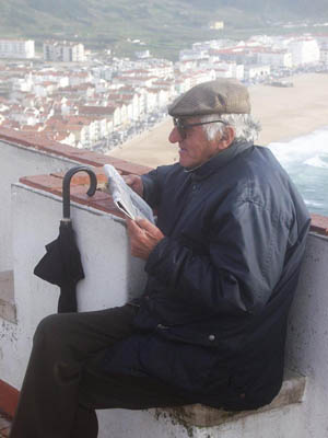 Man reading newspaper, looking for part time jobs for seniors