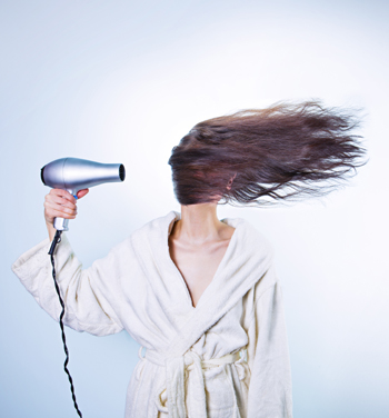 Woman with overpowered hairdryer